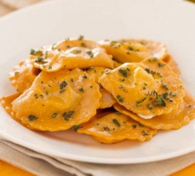 Red ravioli with tomato and olive sauce